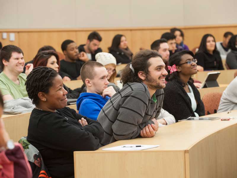 a large classroom full of engaged and smiling v.c.u. students