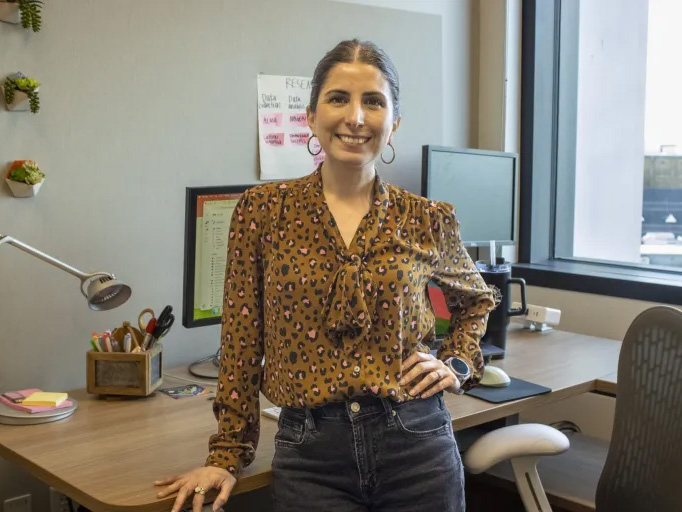 Gabriela Leon Perez stands in front of a desk in her office