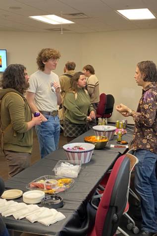 students speaking with a professor