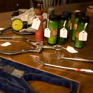 collection of old medical instruments, bottles, and artifacts