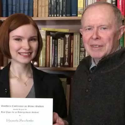 Student Yelyzaveta Shevchenko and her essay award with Professor George Munro