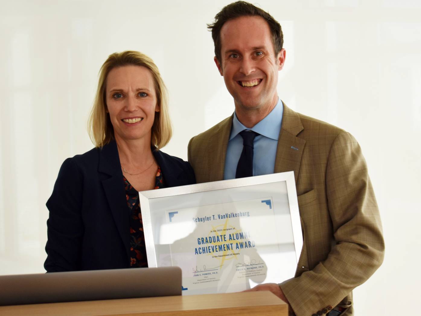 Emily Raymond and Schuyler VanValkenburg holding certificate