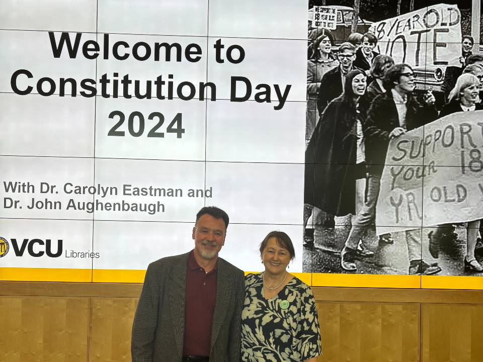 Aughenbaugh and Eastman in front of ppt screen