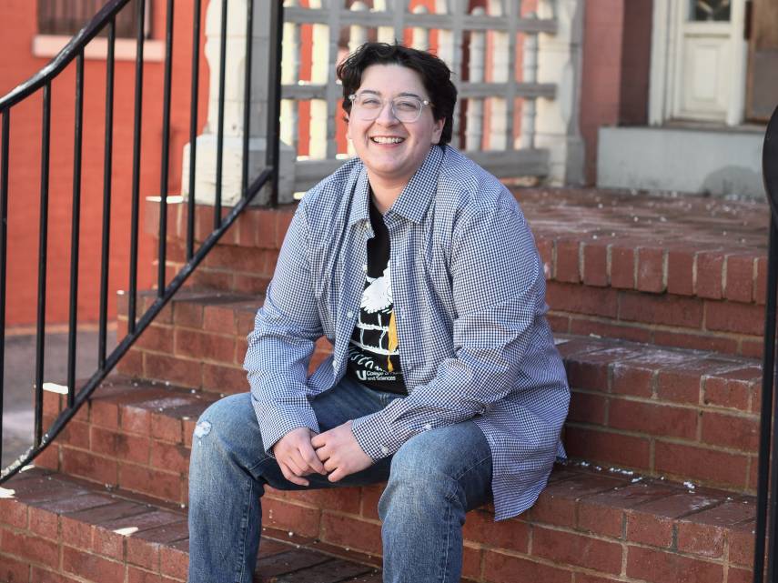 clark kelley sitting on stairs outside of the history building