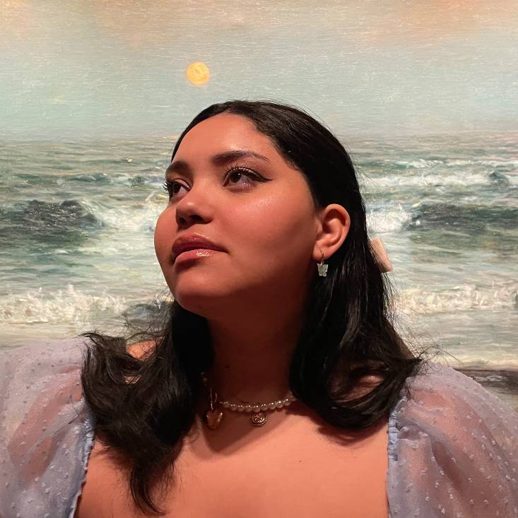 nyah graham in front of a landscape painting